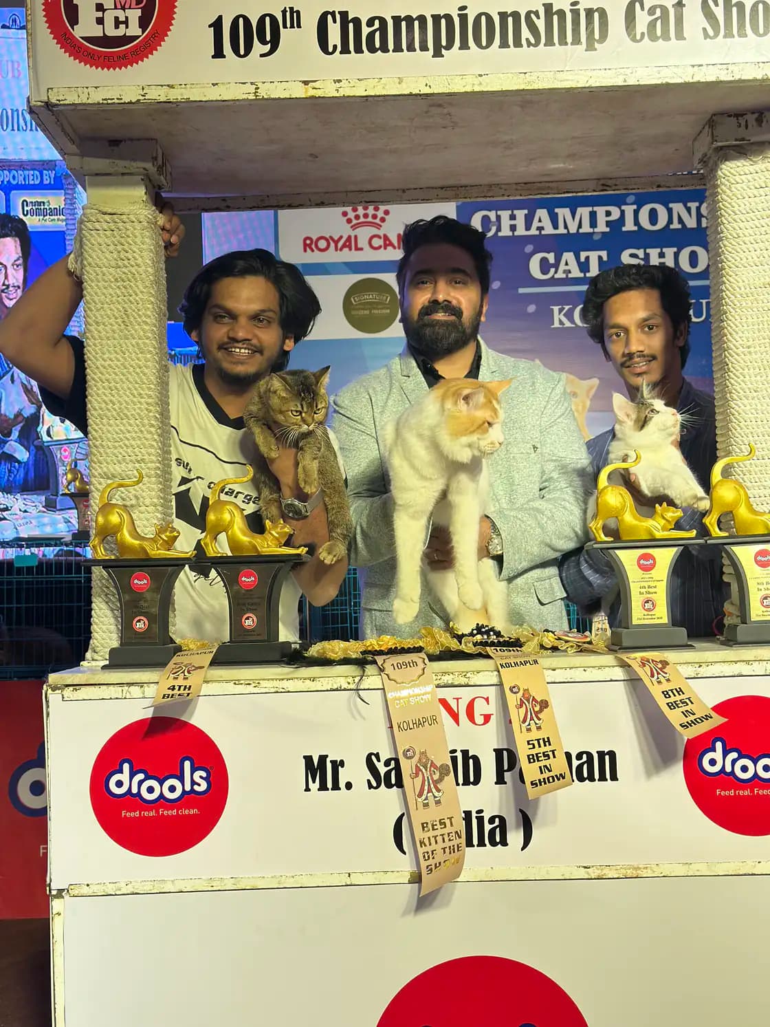 International judge with the Pashas Kitty's Cattery team at a cat show ceremony